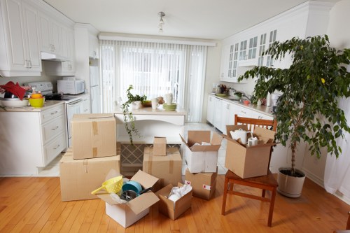 Furniture and boxes being loaded by a man and van team